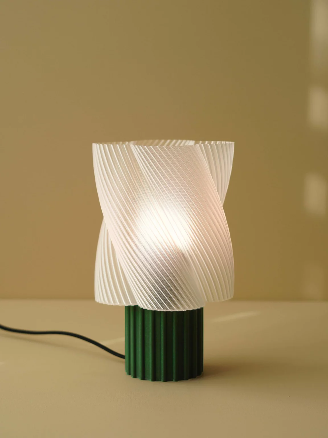 Lampe design en amidon de maïs biodégradable, coloris lait-menthe, avec cordon textile noir.