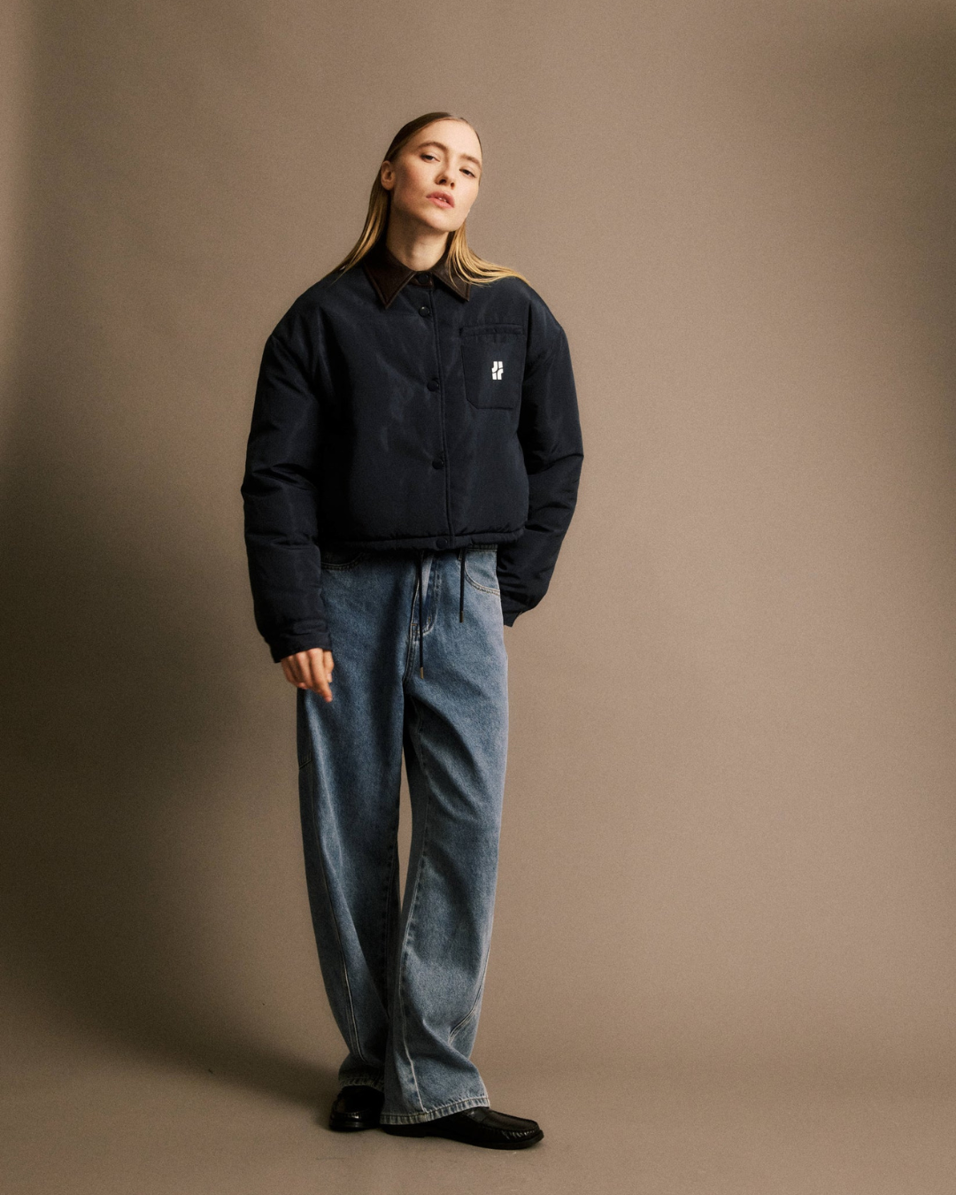 Doudoune Alixe bleu marine JIJI Studio, blouson matelassé court avec col marron contrasté, logo poitrine et cordon de serrage, taille S.