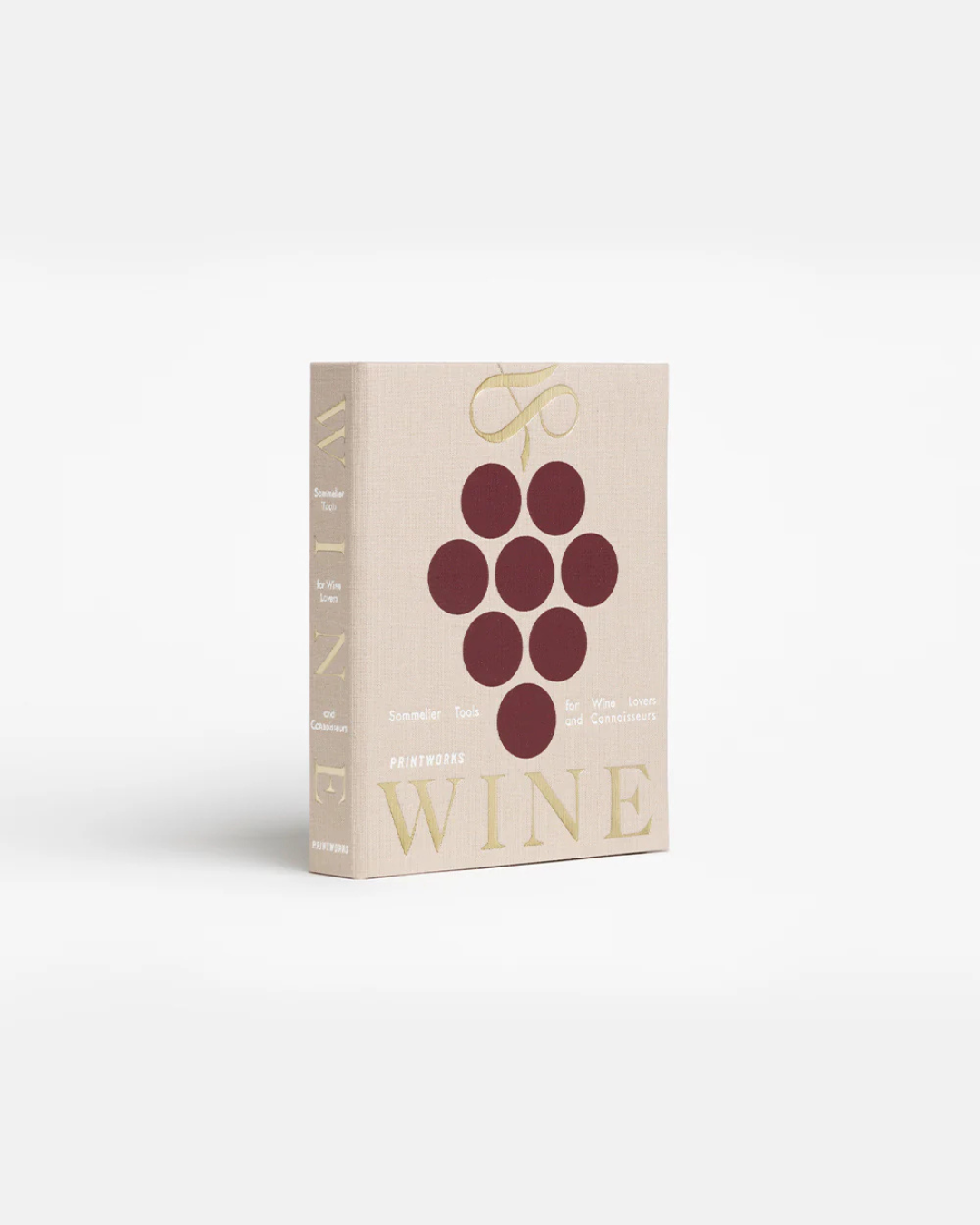 Coffret L’Essentiel du Vin beige en forme de livre, avec tire-bouchon, bouchon, verseur et col anti-gouttes.