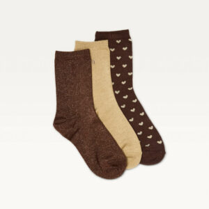 Trois paires de chaussettes Odaje à plat : marron pailletée, champagne pailletée et marron à petits cœurs clairs